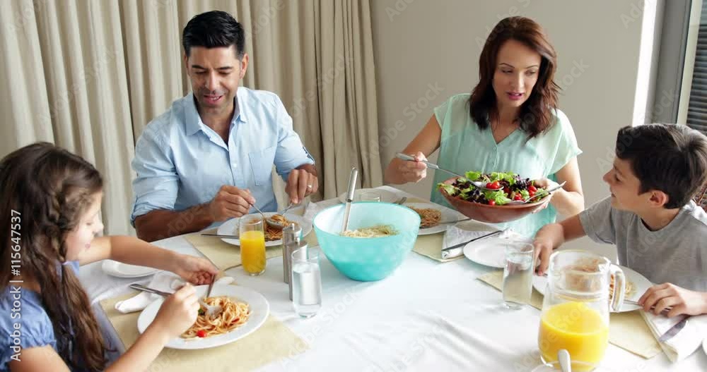 Happy family having a spaghetti dinner together Happy family having a spaghetti dinner together