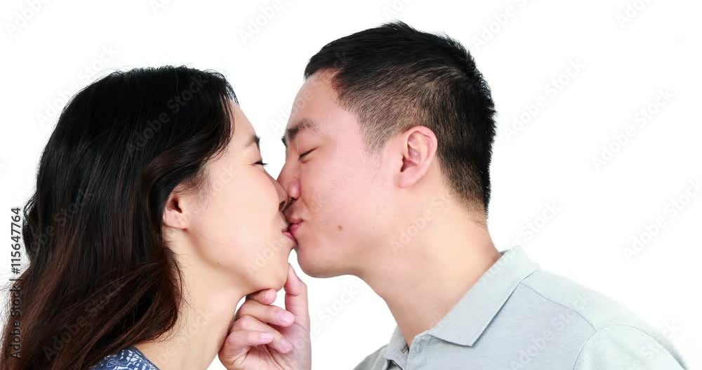 Happy couple kissing and smiling on white screen Happy couple kissing and smiling on white screen