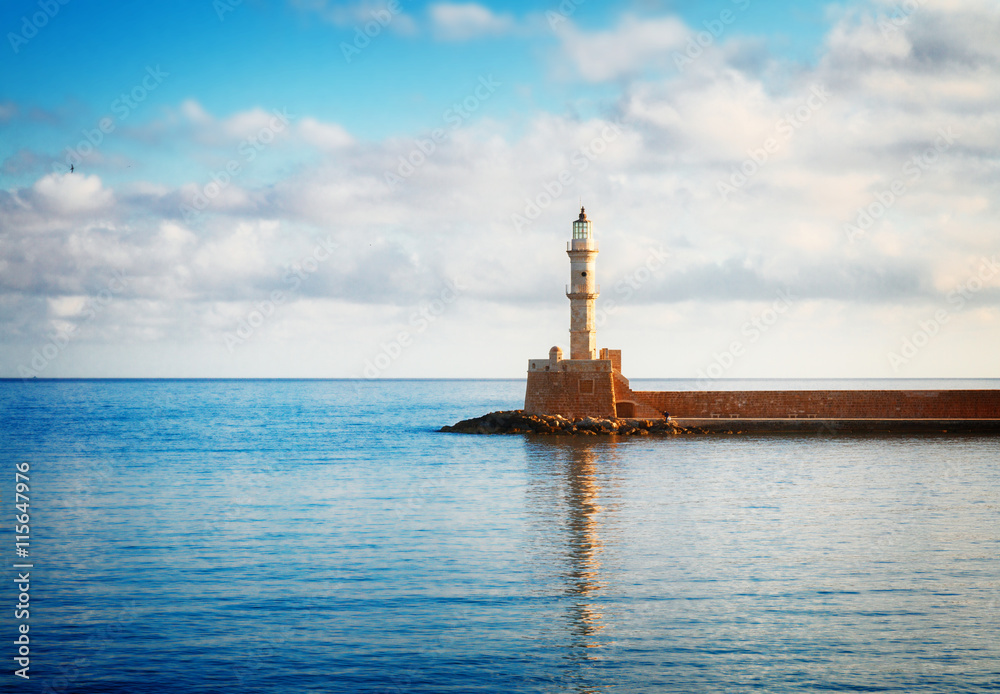 bay of Chania with watrs of Aegan sea and lighthouse at sunny summer morning, Crete Greece, toned