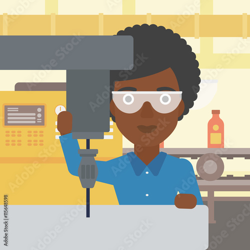 Woman working on milling machine.