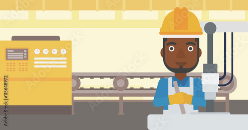 Man working on industrial drilling machine.