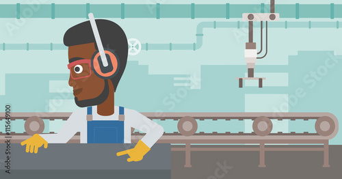 Man working on metal press machine.