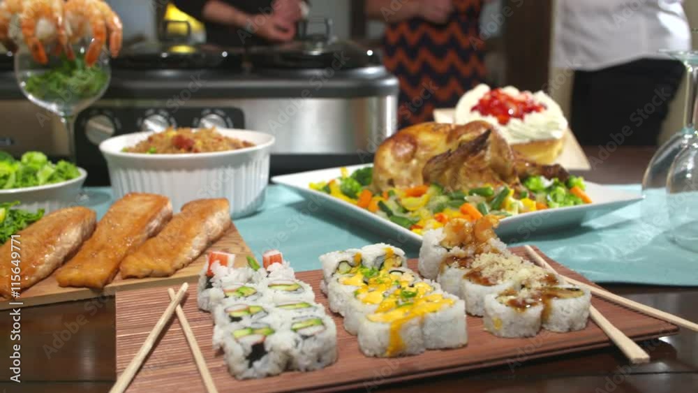 Table of Food For Party Move Left. camera moves left on a table filled with food for a party. Chicken, sushi, salmon, shrimp, pork roast, cheese, crackers, bread, rice and more
Table of Food For Party Move Left. camera moves left on a table filled with food for a party. Chicken, sushi, salmon, shrimp, pork roast, cheese, crackers, bread, rice and more