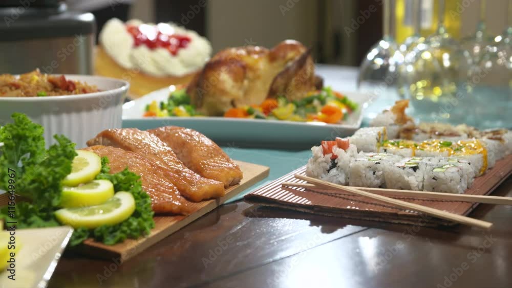 Table with Food Rack Focus. rack focus from chicken to salmon on table with sushi and wine glasses

