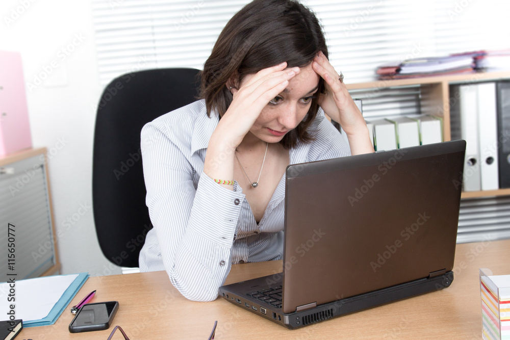Overworked and fed up young woman in front of computer Overworked and fed up young woman in front of computer
