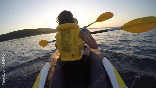 Father and daughter on kayak on a lake