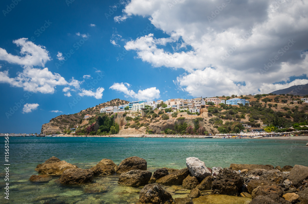 Agia Galini Beach in Crete island, Greece. Tourists relax and bath in crystal clear water of Agia Galini Beach.