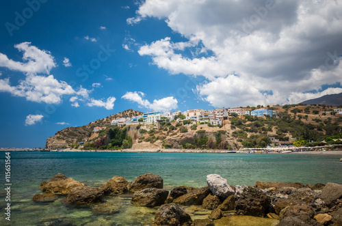 Agia Galini Beach in Crete island, Greece. Tourists relax and bath in crystal clear water of Agia Galini Beach.