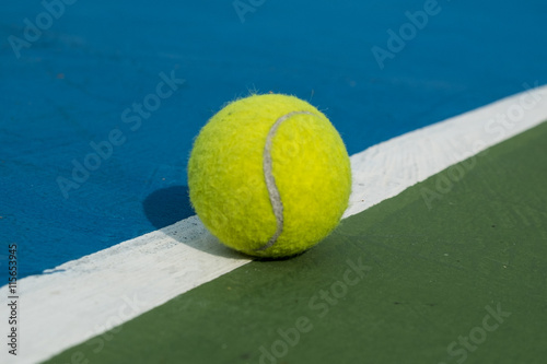 tennis ball on a court line © lunx