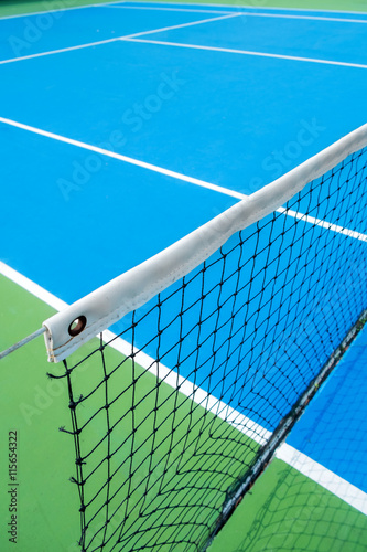 tennis net on blue tennis court