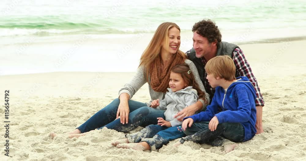 Family sitting on the beach Family sitting on the beach