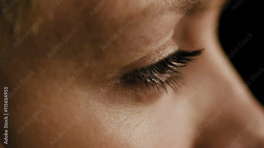 Female woman's eyes closeup side view slow motion. 4K UHD video footage.