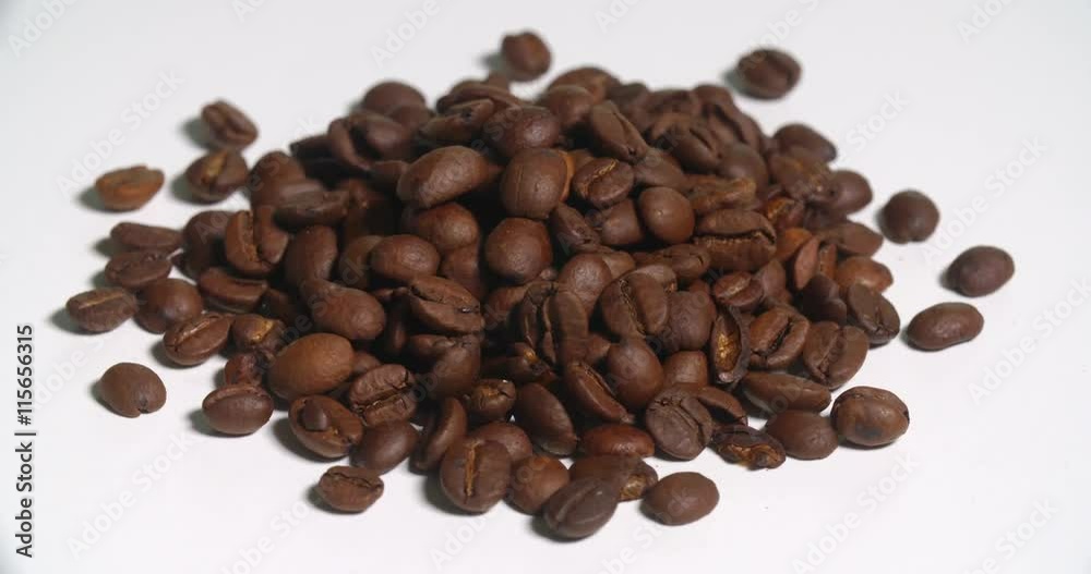 Coffee Beans Pile Uncooked Spinning on White. a pile of brown coffee beans spins left on white
Coffee Beans Pile Uncooked Spinning on White. a pile of brown coffee beans spins left on white