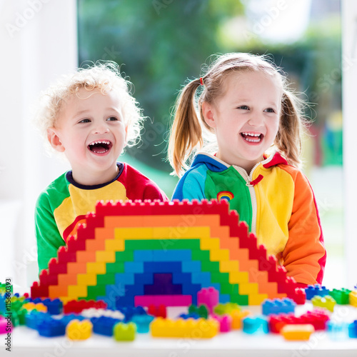 Kids playing with colorful blocks © famveldman