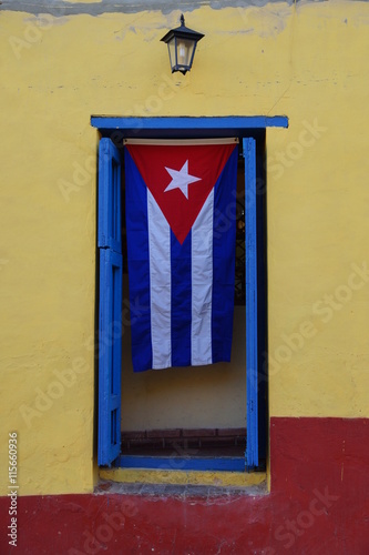 Cuban flag hanging on a door in Trinidad © rasferret