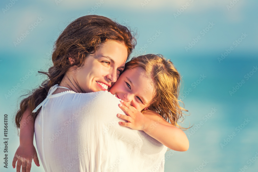 Portrait of happy mother and little daughter on sunny beach Portrait of happy mother and little daughter on sunny beach