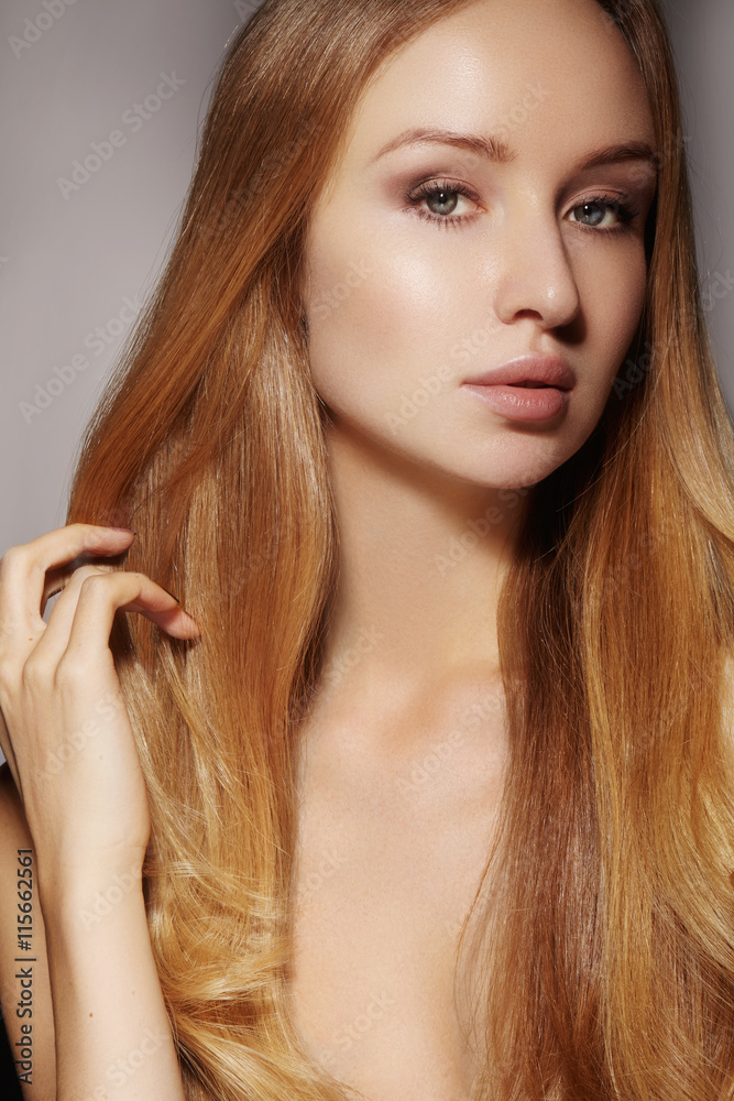 Naklejka premium Beautiful young woman with clean skin, beautiful straight shiny hair, fashion makeup. Glamour make-up, perfect shape eyebrows. Portrait sexy blondy. Beautiful smooth hairstyle. Shiny nail polish