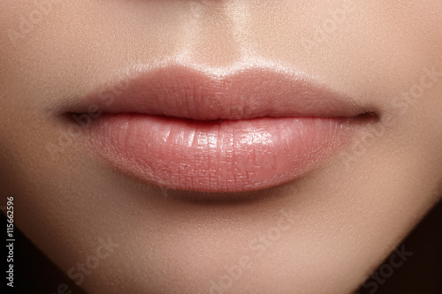 Perfect natural lip makeup. Close up macro photo with beautiful female mouth. Plump full lips. Close-up face detail. Perfect clean skin, light fresh lip make-up. Beautiful spa tender lip

 photo