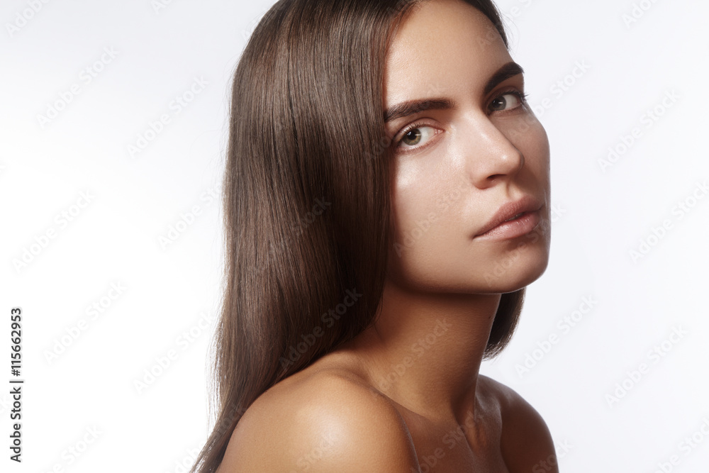 Beautiful young woman with clean face, shiny skin, fashion natural make-up, perfection eyebrows. Cute bun hairstyle. Spa portrait, naturel cosmetics, healthy fresh look Beautiful young woman with clean face, shiny skin, fashion natural make-up, perfection eyebrows. Cute bun hairstyle. Spa portrait, naturel cosmetics, healthy fresh look