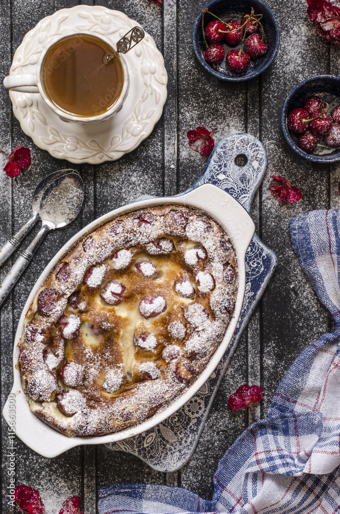Clafoutis with cherries and powdered sugar for breakfast Clafoutis with cherries and powdered sugar for breakfast