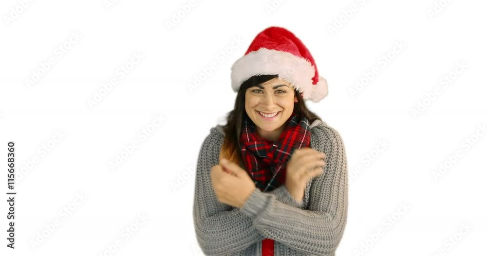 Woman in santa hat and warm clothing blowing over hands on white background Woman in santa hat and warm clothing blowing over hands on white background