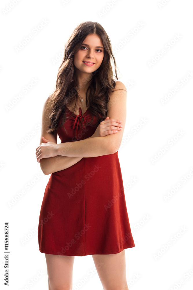 Lady in red keyhole dress. Woman with crossed arms smiling. Model wears new evening dress. Kindness and charm. Lady in red keyhole dress. Woman with crossed arms smiling. Model wears new evening dress. Kindness and charm.