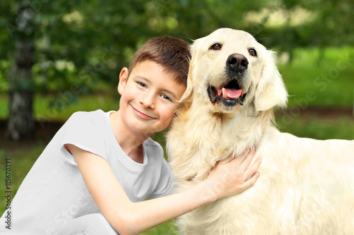 Small boy and cute dog in park