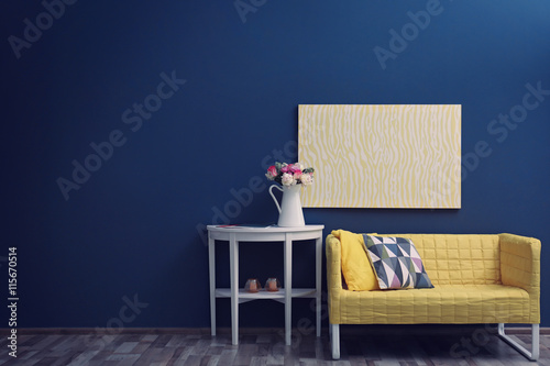 Modern room interior with stylish furniture and fresh roses on table