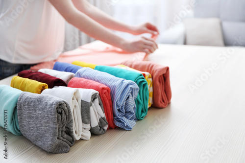 Woman folding clothes on table