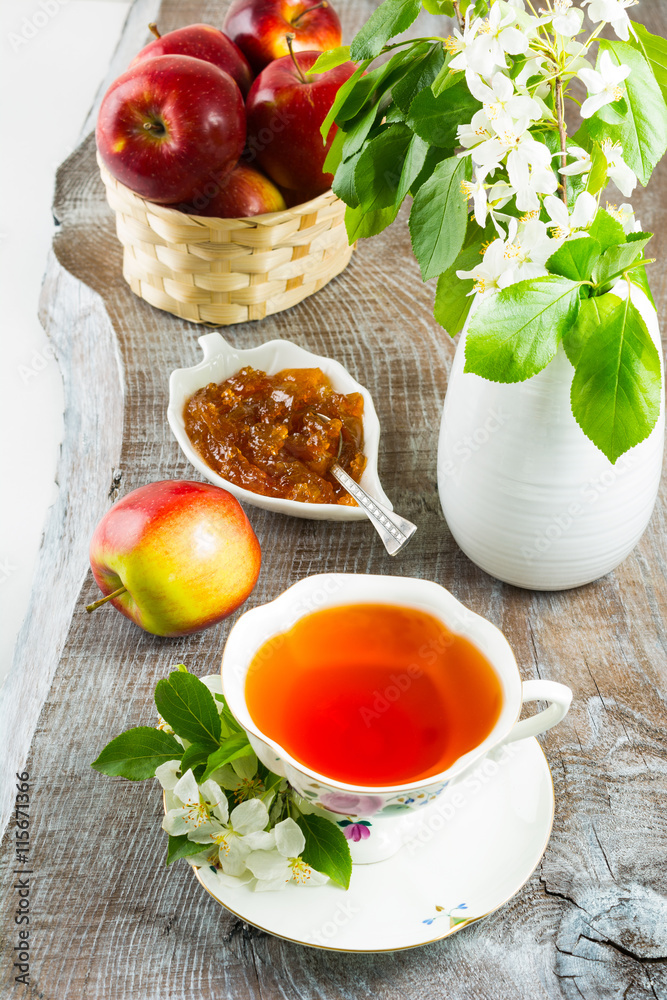 Cup of tea and apple jam on rustic wooden table Cup of tea and apple jam on rustic wooden table