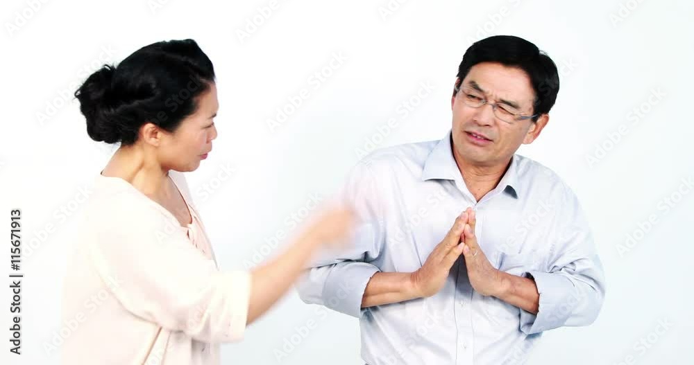 Mature Asian couple arguing on white screen Mature Asian couple arguing on white screen