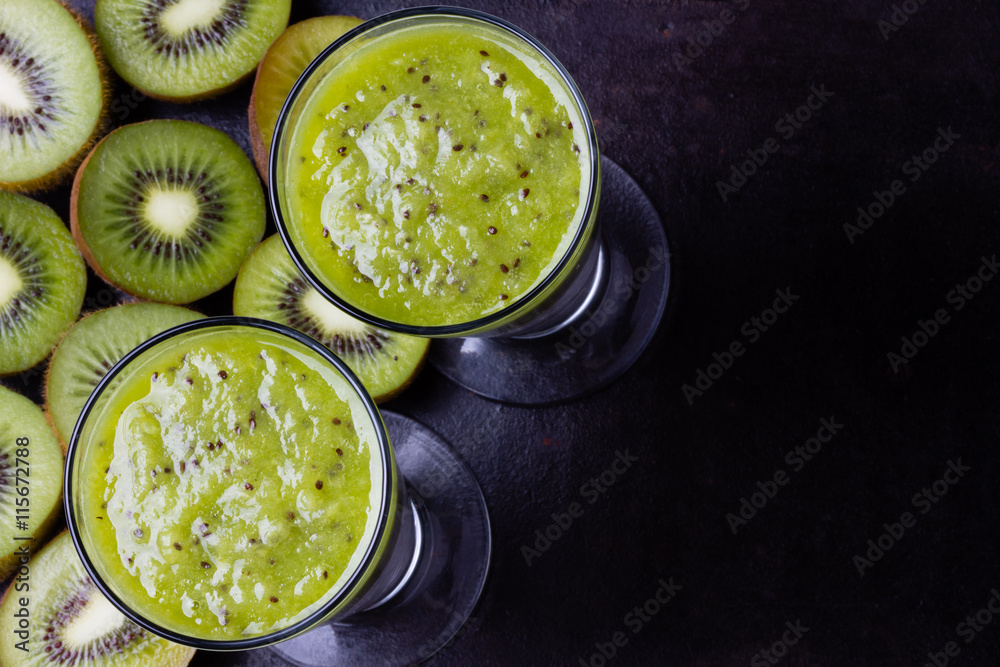 Kiwi smoothie with fresh fruits on black background. Top view Kiwi smoothie with fresh fruits on black background. Top view