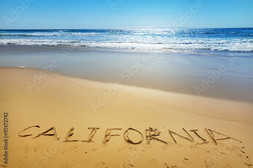 California written on the sand of a beach, vacation concept background