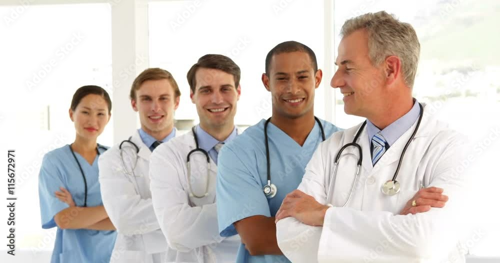 Medical team crossing arms and looking at camera Medical team crossing arms and looking at camera