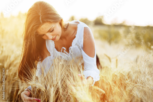 Beautiful woman hugging barley and wheat photo