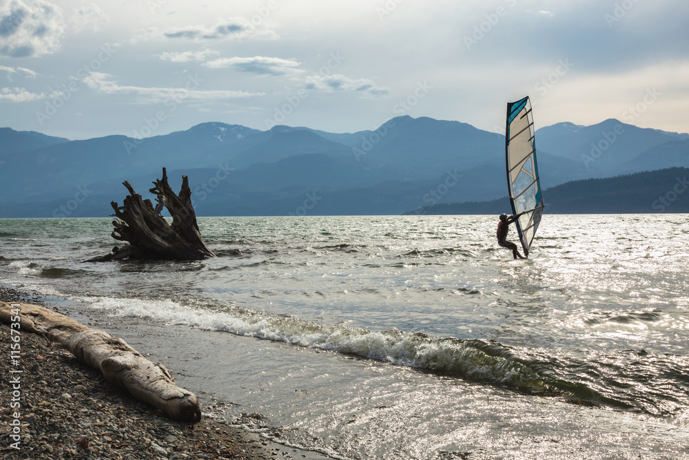 Fototapeta premium Windsurfer surfing in Harrison Lake, British Columbia, Canada.
