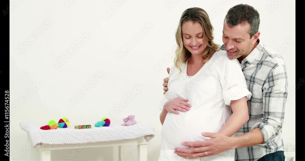 Man embracing his pregnant wife