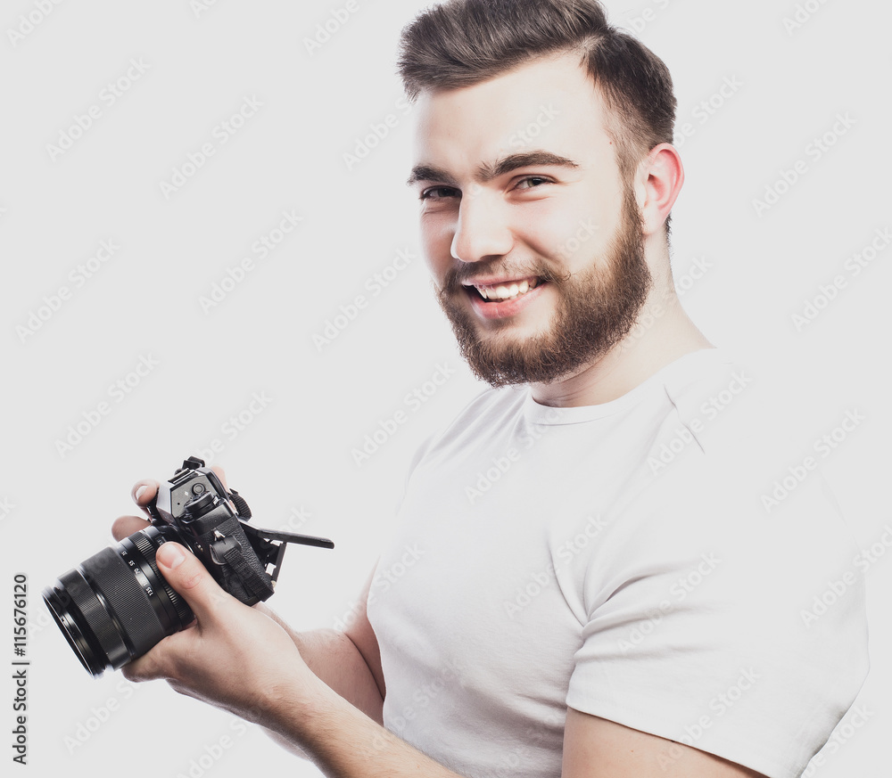 young bearded photographer taking pictures with digital camera. young bearded photographer taking pictures with digital camera.