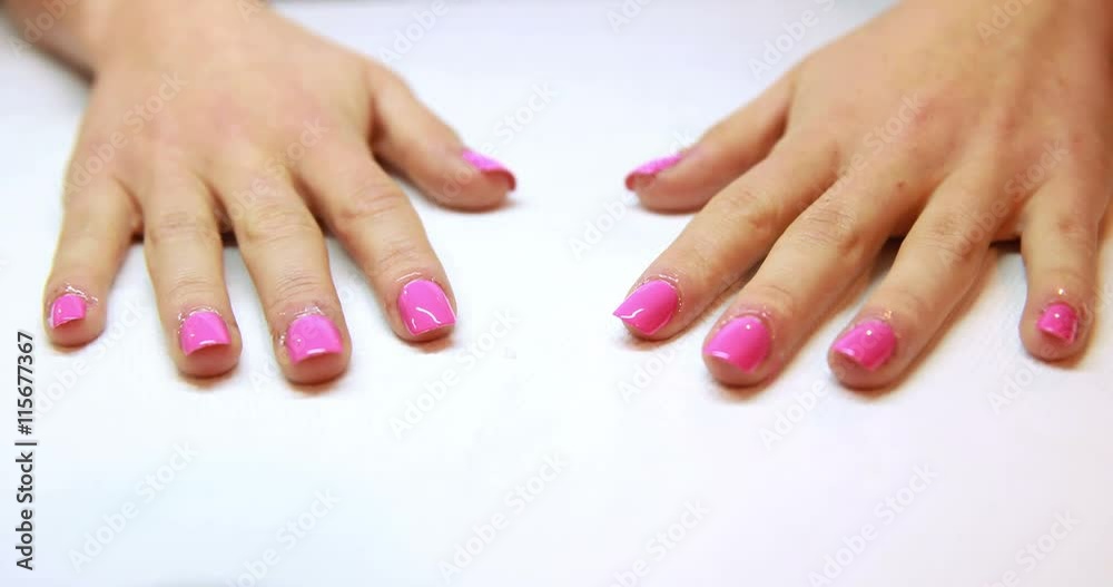 Hands showing fresh pink manicure at the nail salon Hands showing fresh pink manicure at the nail salon