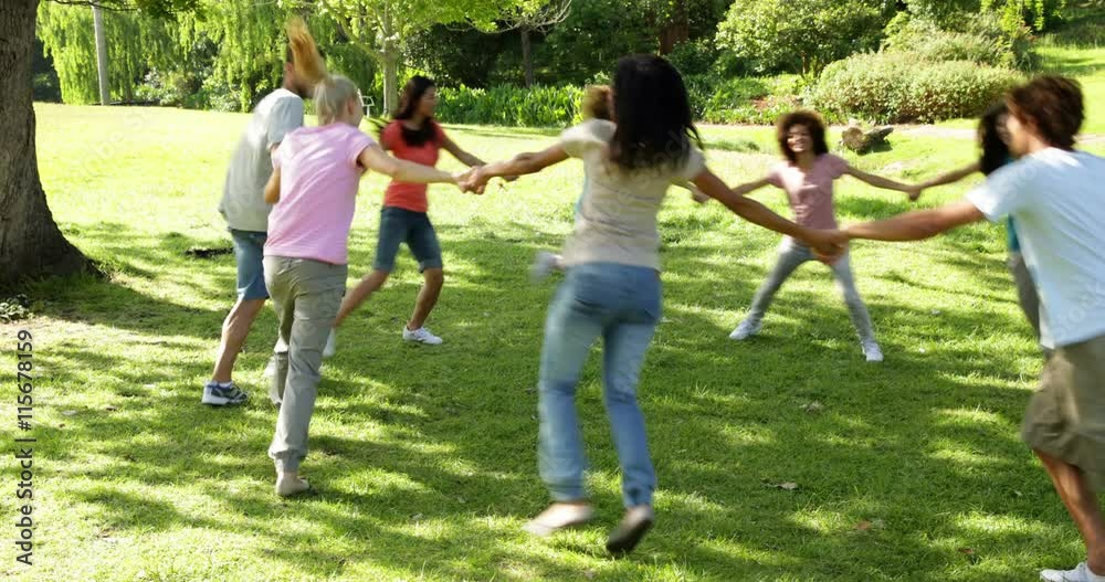 Group of casual young friends playing ring a ring a rosie Group of casual young friends playing ring a ring a rosie
