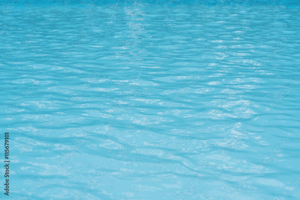 Water in swimming pool with shiny light reflection