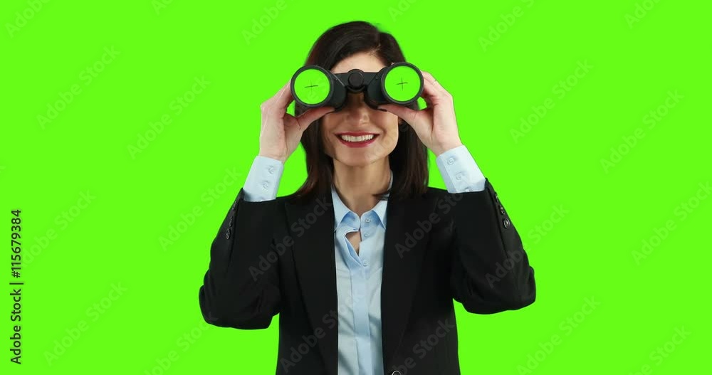 Businesswoman using binoculars on green screen Businesswoman using binoculars on green screen