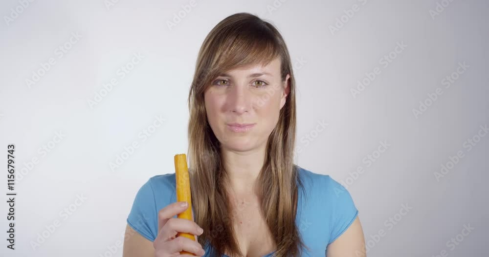 Young healthy woman eating a carrot Young healthy woman eating a carrot