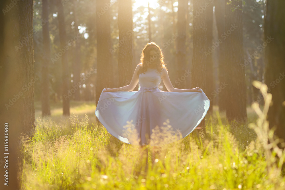 Beautiful young woman wearing elegant light blue dress standing in the ...