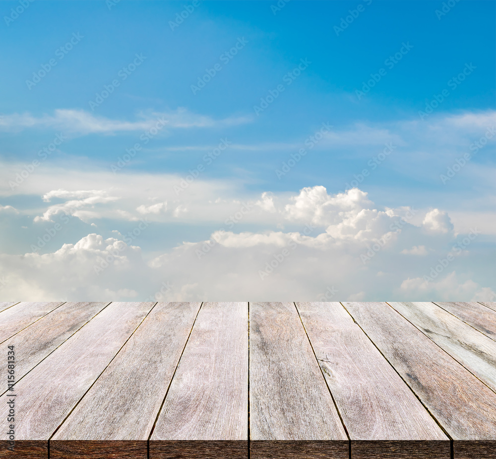 Wooden floor on sky and clouds background