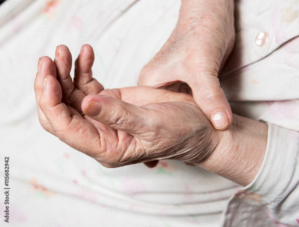 Fototapeta premium Old woman measuring her pulse