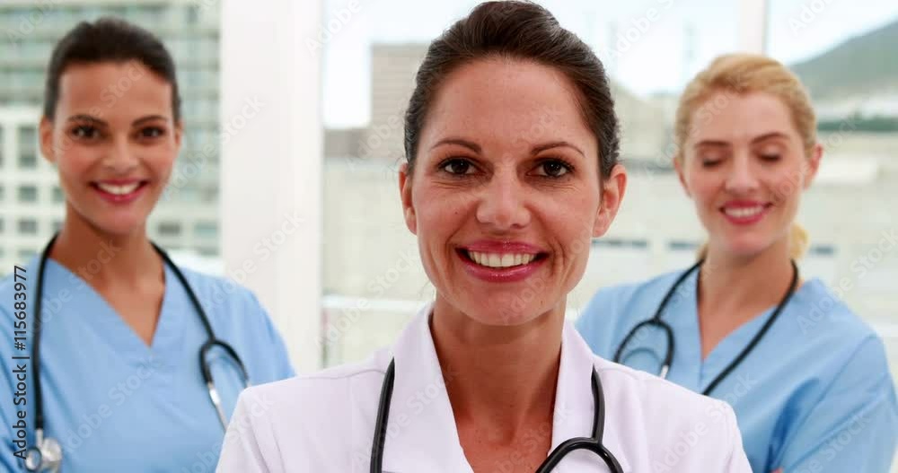 Medical team smiling at camera together at the hospital Medical team smiling at camera together at the hospital