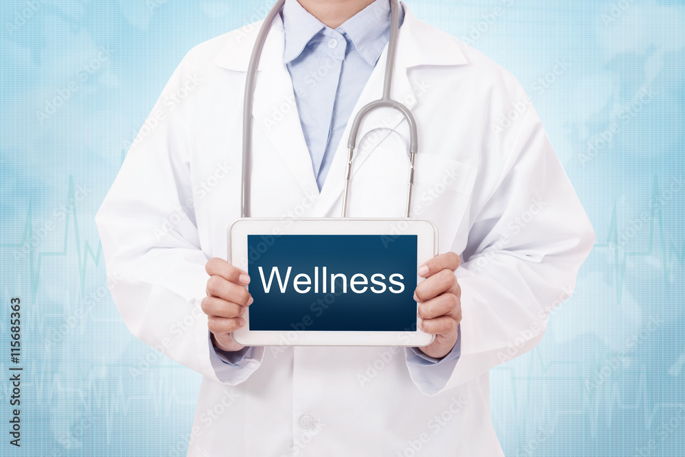 Doctor holding a tablet pc with wellness text on blue background Doctor holding a tablet pc with wellness text on blue background