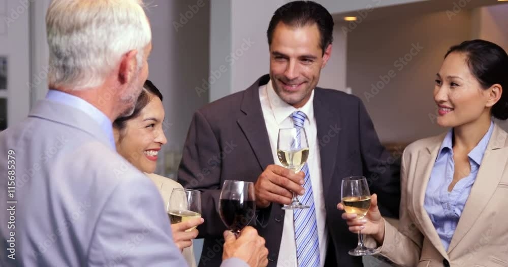 Business team relaxing after work and drinking wine Business team relaxing after work and drinking wine