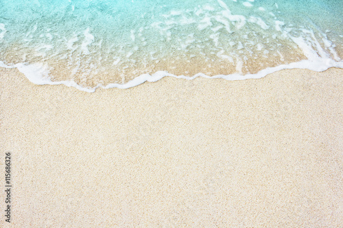 Fotografie, Obraz Soft wave of blue ocean on the sandy beach, background.